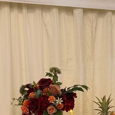 A floral detail from a styled fruit table arranged for a celebratory event.
