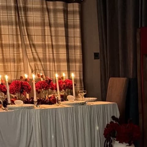 A candlelit detail from a dessert styling setup designed for a reveal moment.