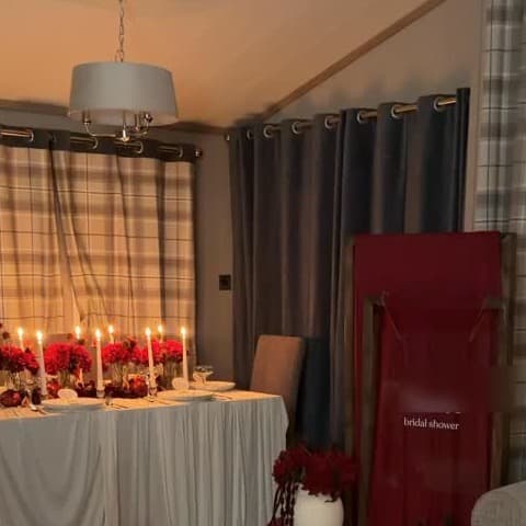 A styled room detail with candles and rich red celebration accents.